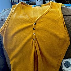 Yellow knitted tank top with buttons.